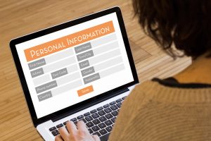 filling out personal information on laptop